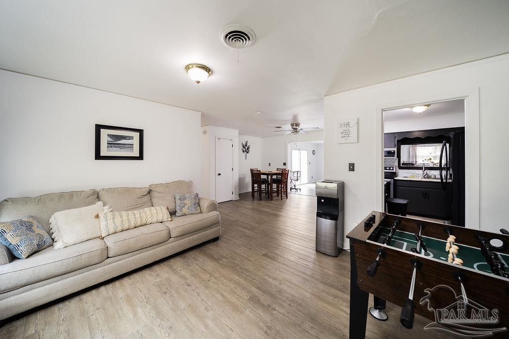 6841 Data Street Pensacola, FL 32504 - Photo 5 of 25 a living room with furniture and a wooden floor