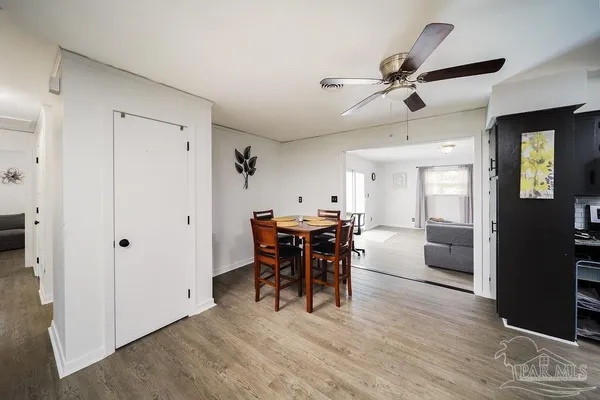 a view of a dining room with furniture and wooden floor