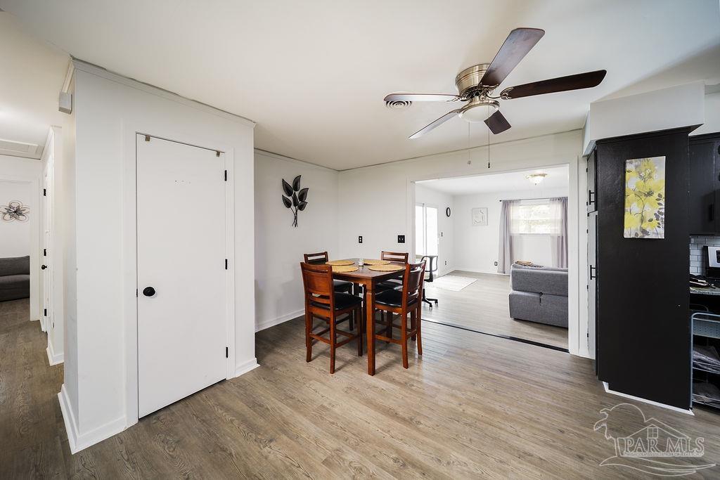 6841 Data Street Pensacola, FL 32504 - Photo 7 of 25 a view of a dining room with furniture and wooden floor