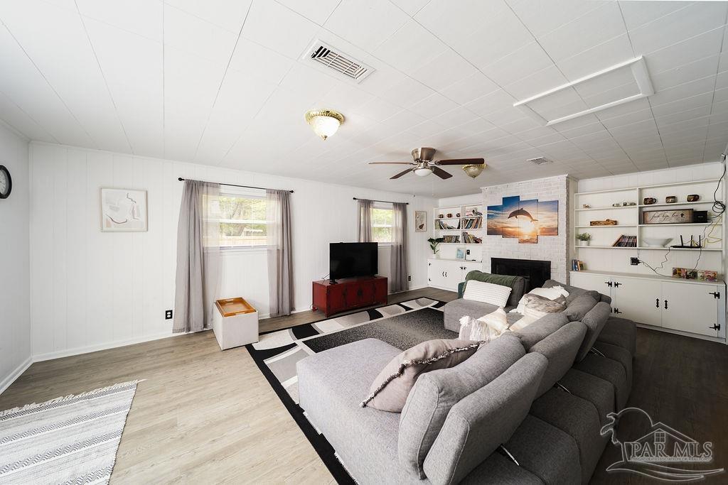 6841 Data Street Pensacola, FL 32504 - Photo 9 of 25 a living room with furniture and a flat screen tv
