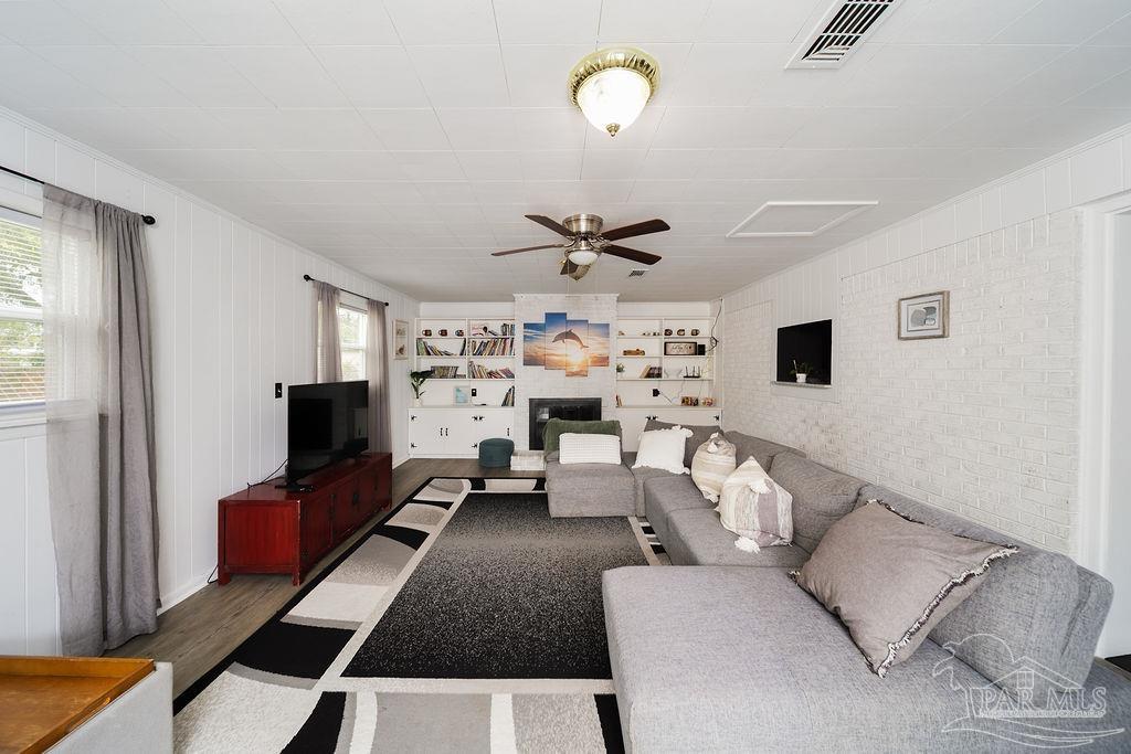 6841 Data Street Pensacola, FL 32504 - Photo 10 of 25 a living room with furniture a flat screen tv and a window