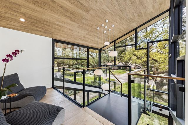 a kitchen with a sink and chairs