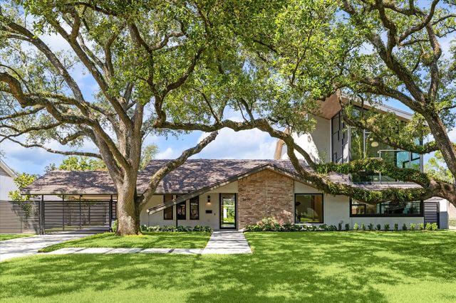 a large tree in front of a house