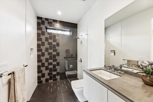 a living room with furniture and floor to ceiling windows