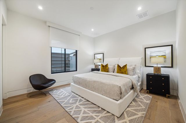 a bathroom with a granite countertop sink a toilet a shower and a mirror