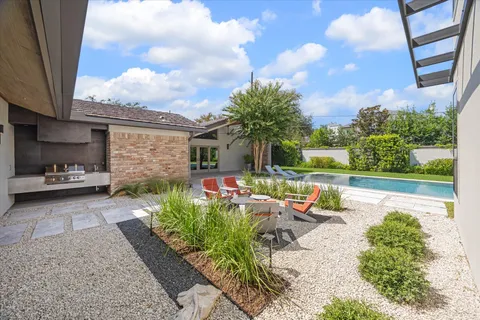 a view of a patio with table and chairs and potted plants
