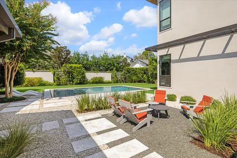 a backyard of a house with outdoor seating
