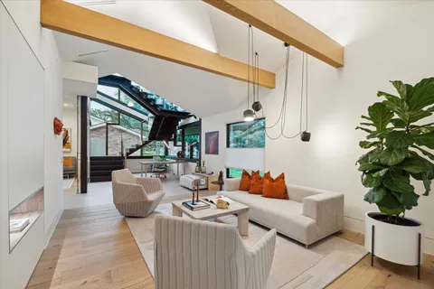 a living room with patio furniture and a potted plants
