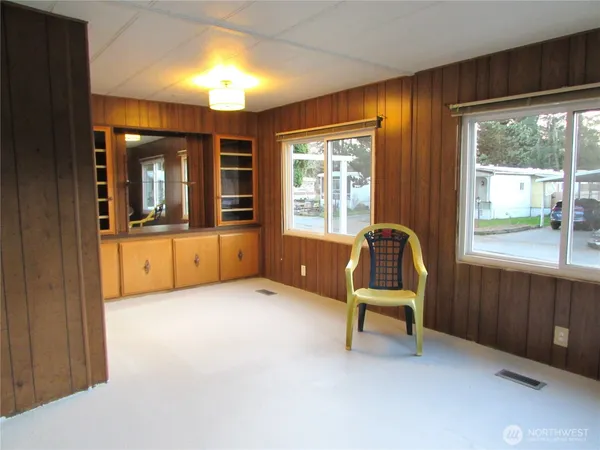 a living room with furniture and large windows
