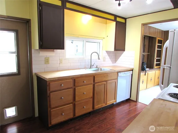 a spacious bathroom with a granite countertop sink and a mirror