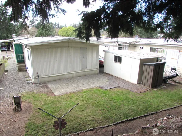 a view of a house with a yard and sitting area