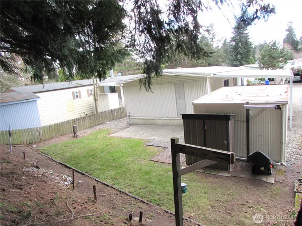 a view of a backyard with a sink and a wooden fence