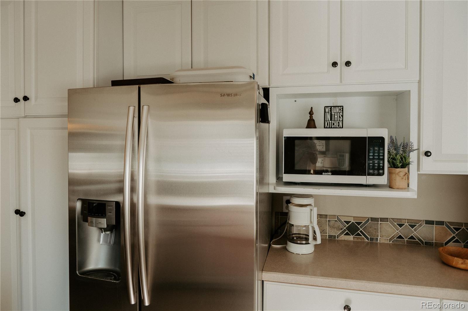 10340 West 100th Place Westminster, CO 80021 - Photo 11 of 25 a kitchen with a refrigerator and cabinets