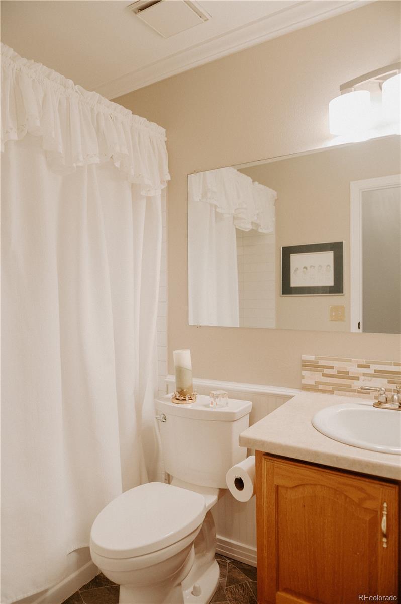 10340 West 100th Place Westminster, CO 80021 - Photo 16 of 25 a bathroom with a sink a toilet and a mirror