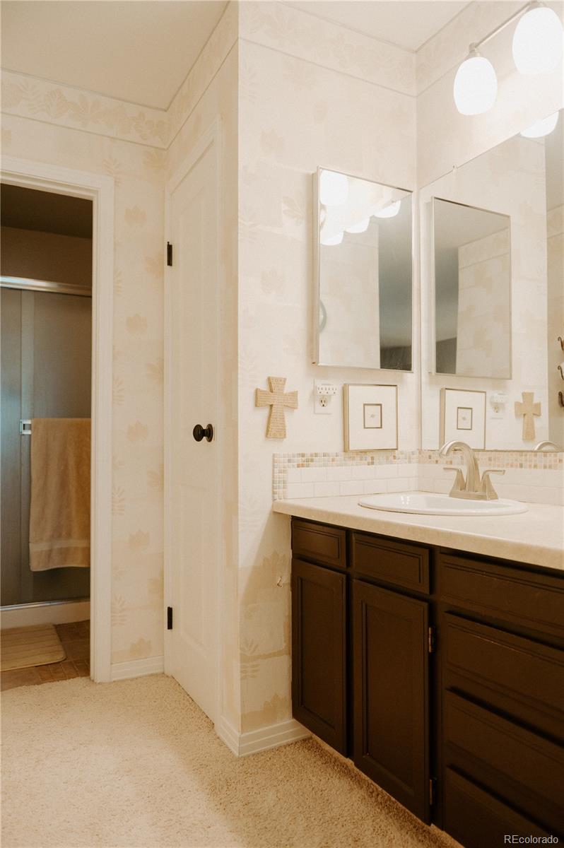 10340 West 100th Place Westminster, CO 80021 - Photo 20 of 25 a bathroom with double sink and a mirror