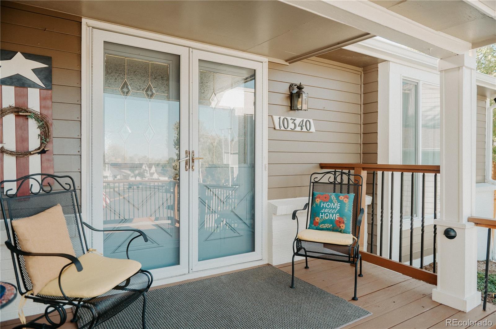 10340 West 100th Place Westminster, CO 80021 - Photo 2 of 25 a balcony with table and a chair