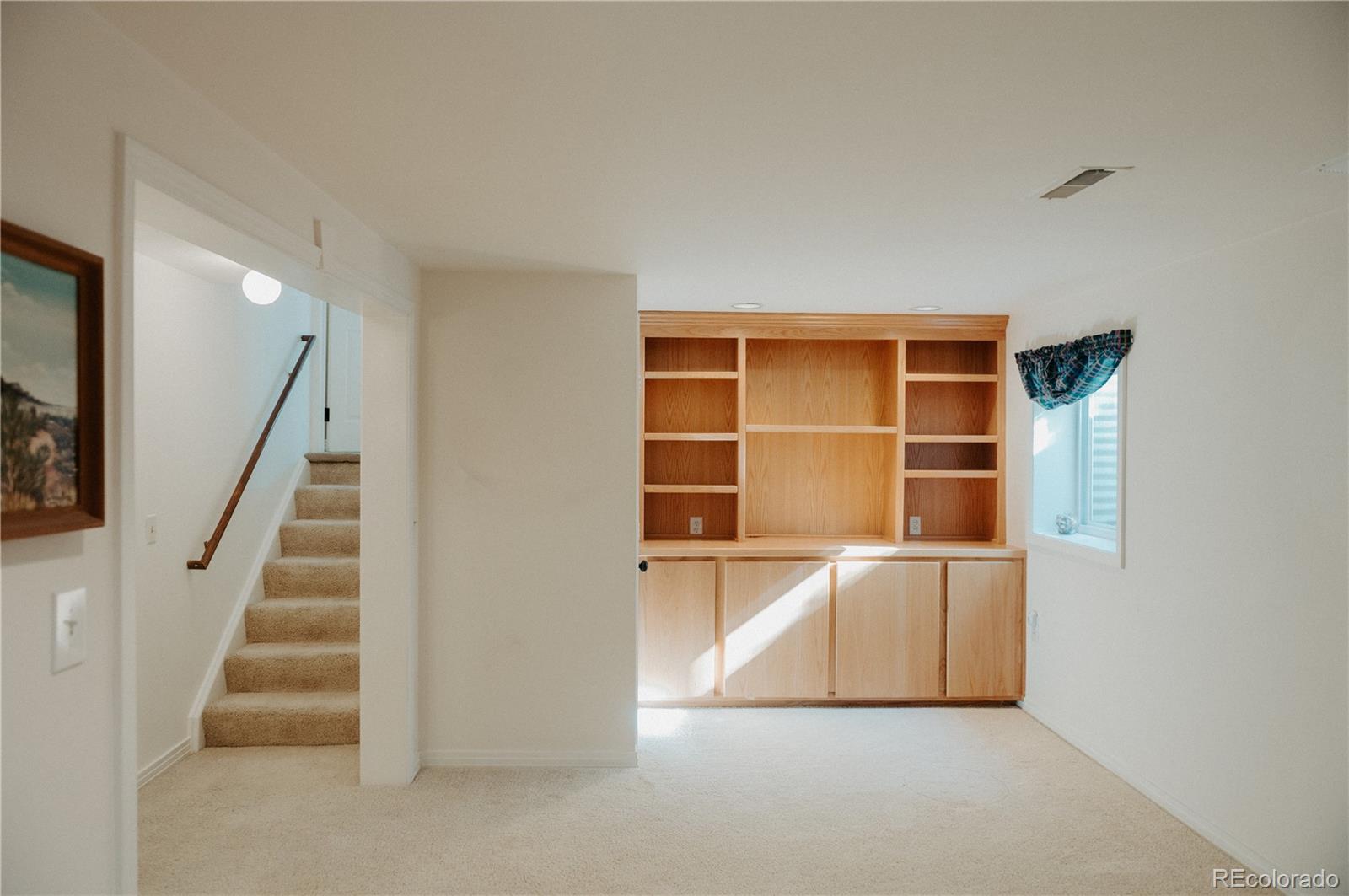 10340 West 100th Place Westminster, CO 80021 - Photo 21 of 25 an empty room with wooden floor and windows