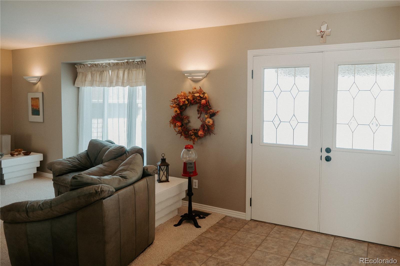 10340 West 100th Place Westminster, CO 80021 - Photo 4 of 25 a living room with furniture and a potted plant