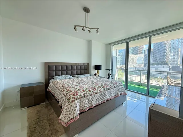 a bedroom with a large bed and a balcony