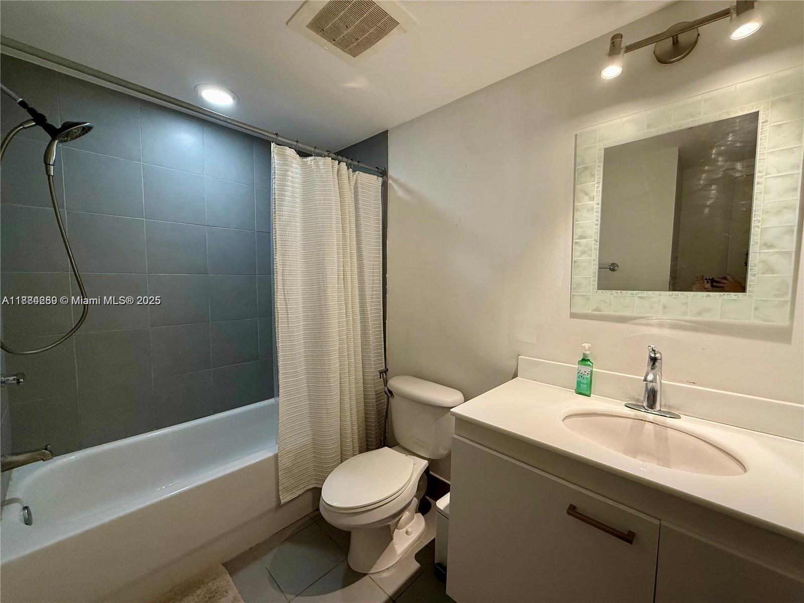 92 Southwest 3rd Street, Unit 1104 Miami, FL 33130 - Photo 10 of 17 a bathroom with a sink toilet and shower