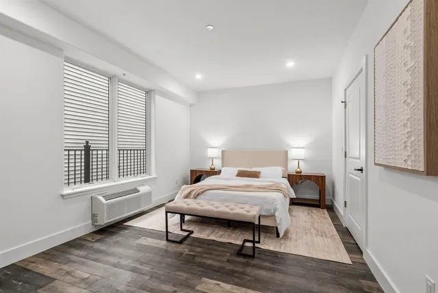 a bedroom with a bed and a window