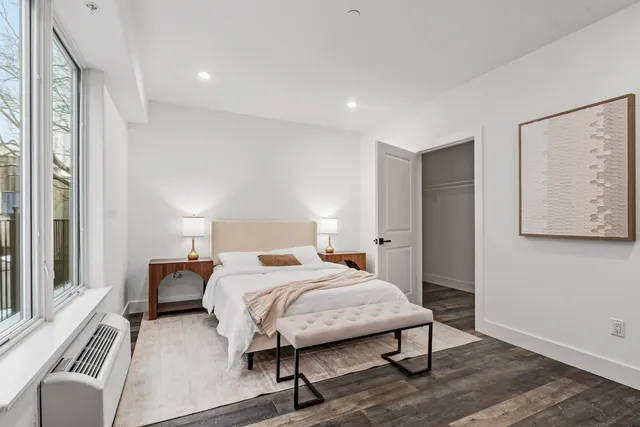 a bedroom with a bed and a chair