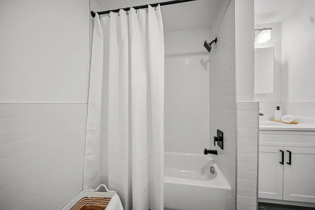 a bathroom with a bathtub and shower