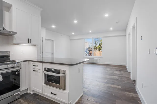 a kitchen with a stove top oven and a refrigerator
