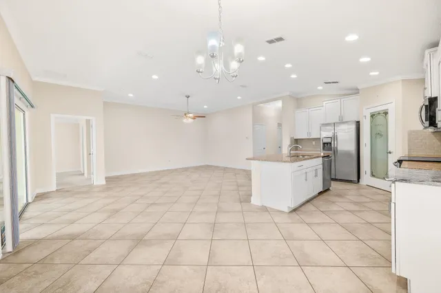 a large kitchen with cabinets and stainless steel appliances