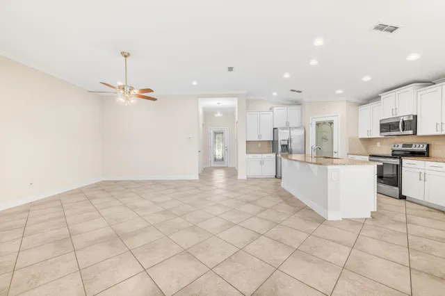 a view of kitchen view with cabinets and refrigerator