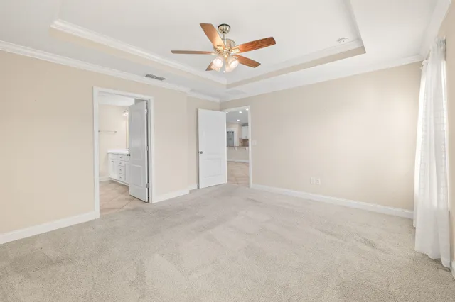 an empty room with closet and ceiling fan