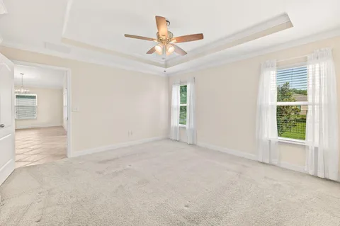 an empty room with closet and windows