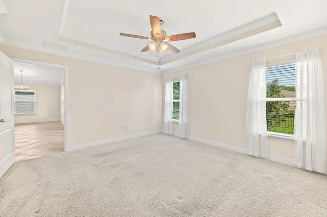 an empty room with closet and windows