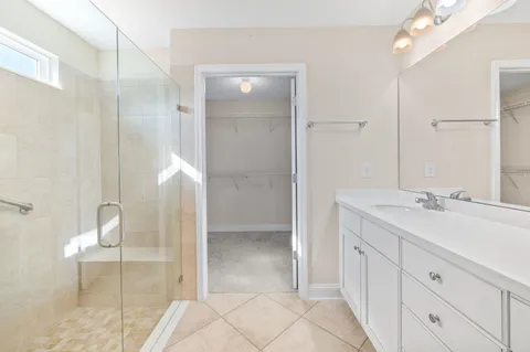 a bathroom with a double vanity sink and mirror