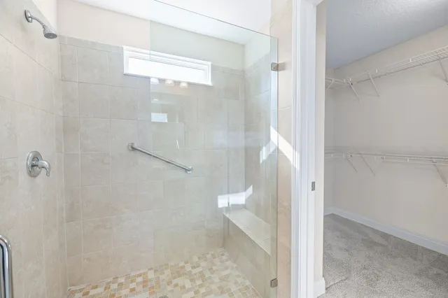 a bathroom with a glass shower door