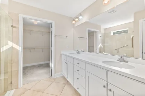 a bathroom with a double vanity sink and mirror