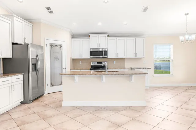 a kitchen with stainless steel appliances granite countertop a refrigerator sink and cabinets
