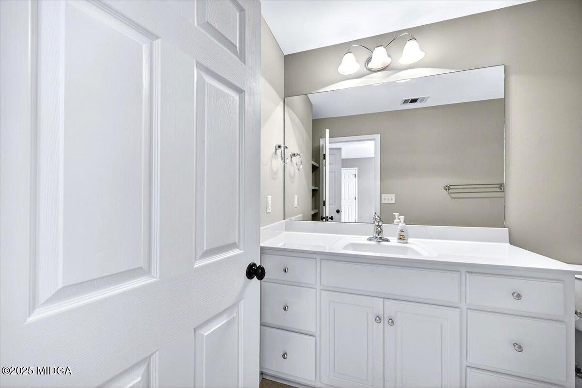 414 Waverly Lane Macon, GA 31210 - Photo 30 of 32 a bathroom with a sink vanity and mirror