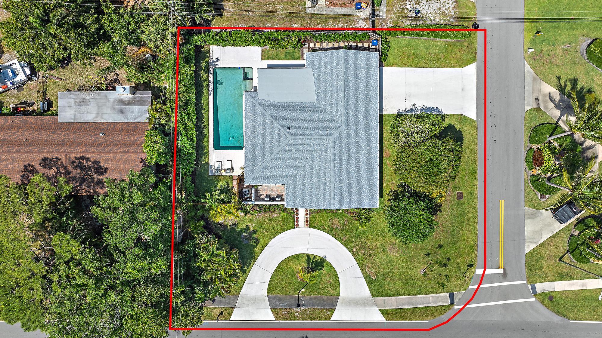 1604 Seabrook Road Tequesta, FL 33469 - Photo 1 of 42 an aerial view of a house with swimming pool and garden