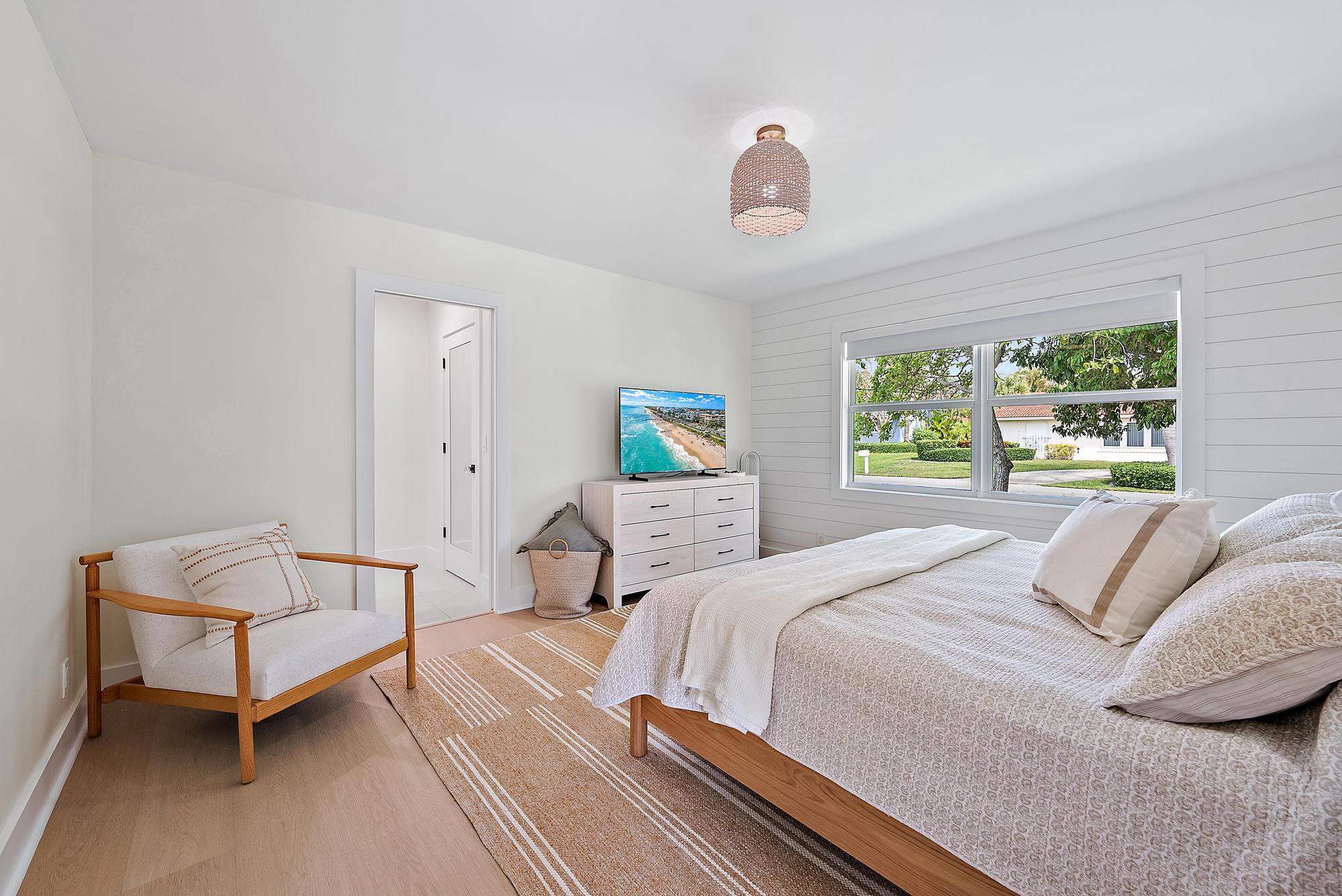 1604 Seabrook Road Tequesta, FL 33469 - Photo 17 of 42 a bedroom with a bed and a window