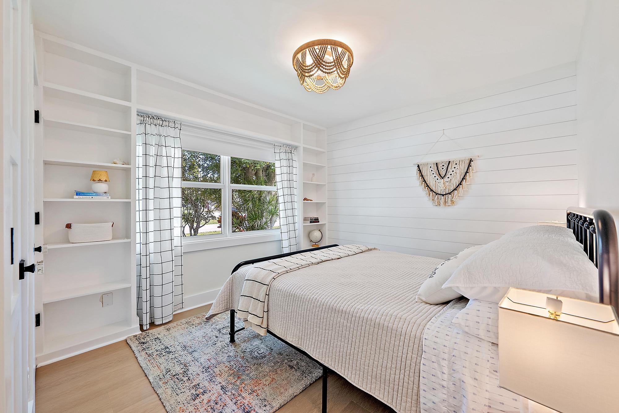 1604 Seabrook Road Tequesta, FL 33469 - Photo 20 of 42 a bedroom with a bed and a window