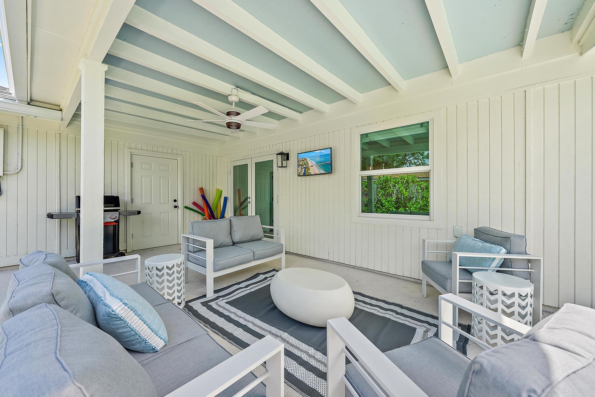 1604 Seabrook Road Tequesta, FL 33469 - Photo 23 of 42 a living room with furniture and a large window