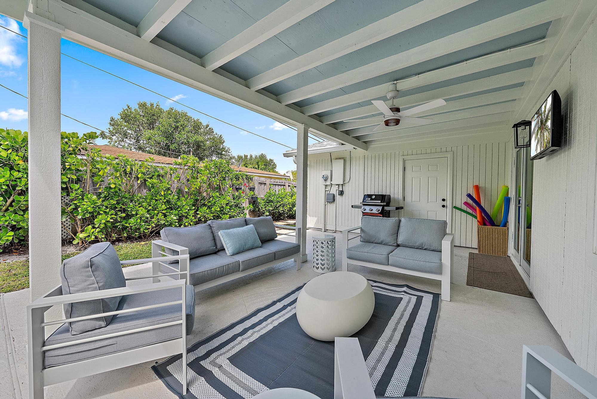 1604 Seabrook Road Tequesta, FL 33469 - Photo 25 of 42 a living room with furniture and a large window
