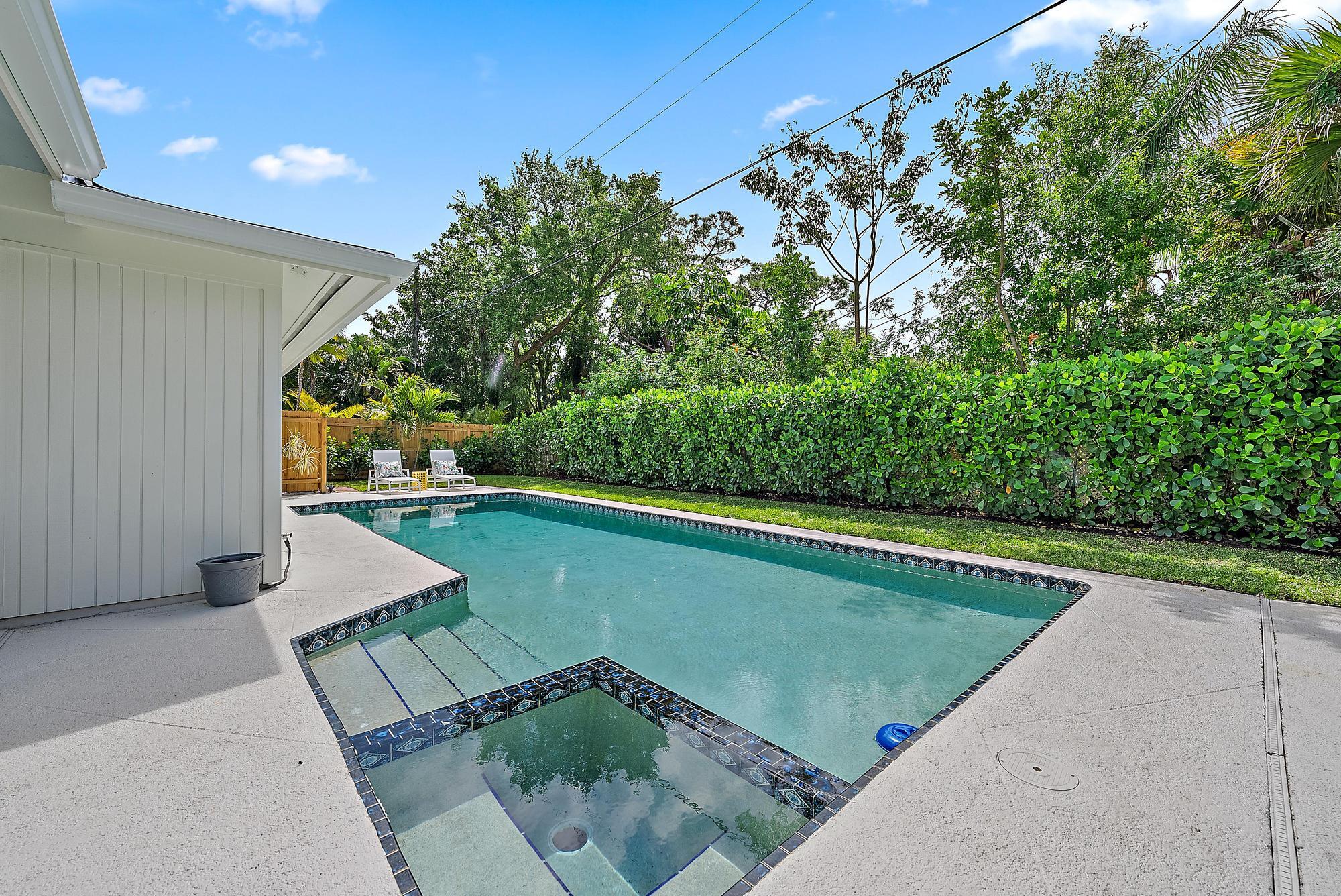 1604 Seabrook Road Tequesta, FL 33469 - Photo 26 of 42 a view of a swimming pool with a yard