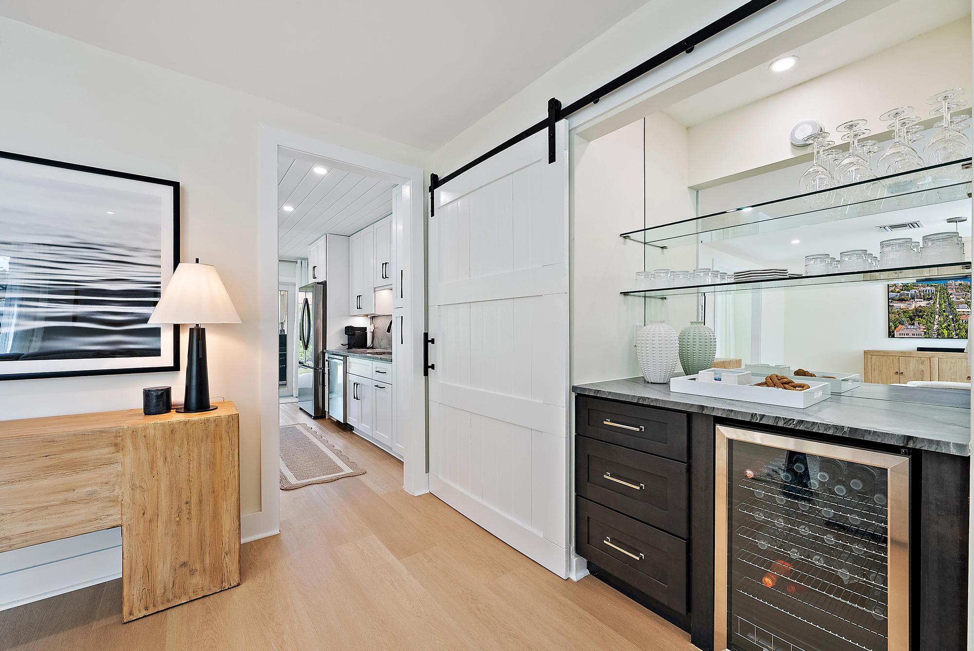 1604 Seabrook Road Tequesta, FL 33469 - Photo 7 of 42 a kitchen with a refrigerator and countertop