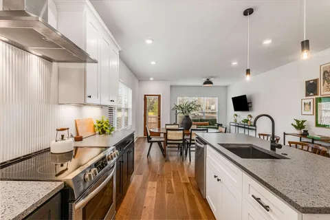a kitchen with sink stove and cabinets