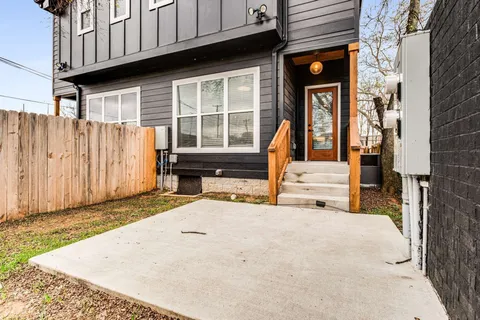 a view of a house with wooden fence