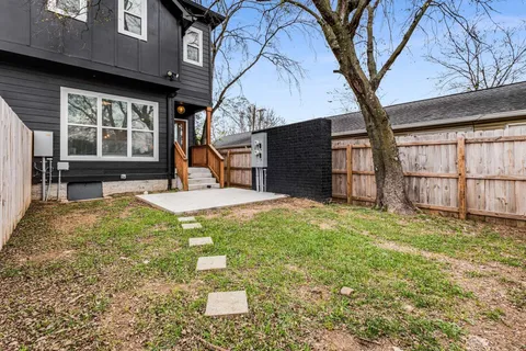 a view of a backyard with a large tree