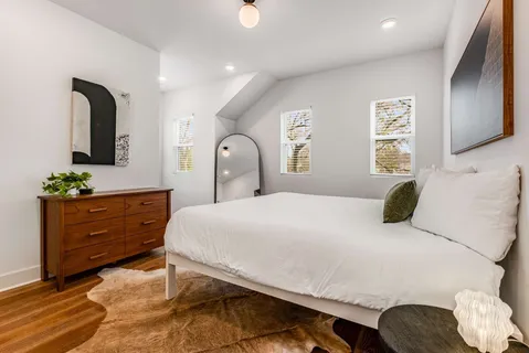 a bedroom with a bed and a dresser