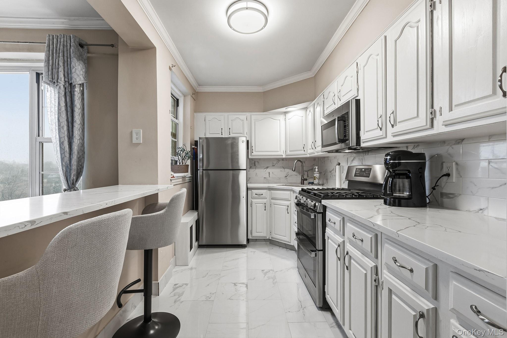 210 Pelham Road, Unit 6E New Rochelle, NY 10805 - Photo 6 of 15 a kitchen with stainless steel appliances granite countertop a refrigerator a stove top oven a sink and dishwasher
